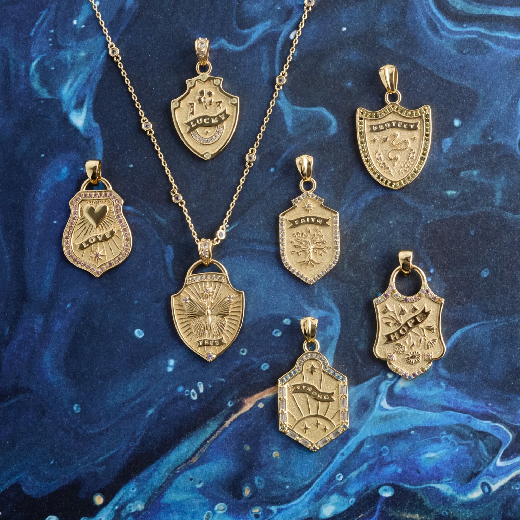 Stylized shot of shield pendants on blue background