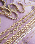 Stylized shot of assorted chain styles on purple background