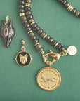 Stylized shot of fox pendants and obsidian beaded necklace