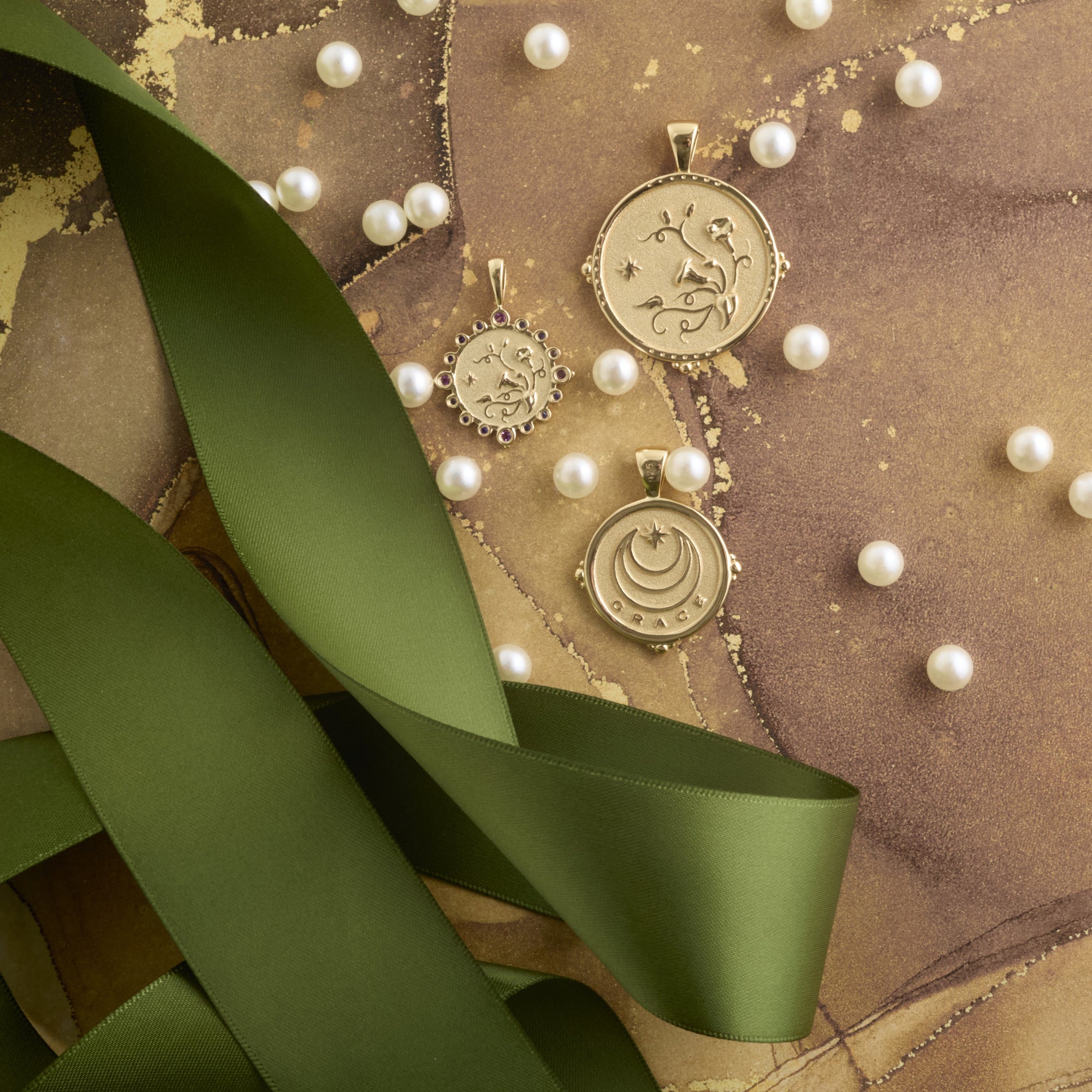 Stylized shot of each coin in the Grace collection on brown background with green ribbons
