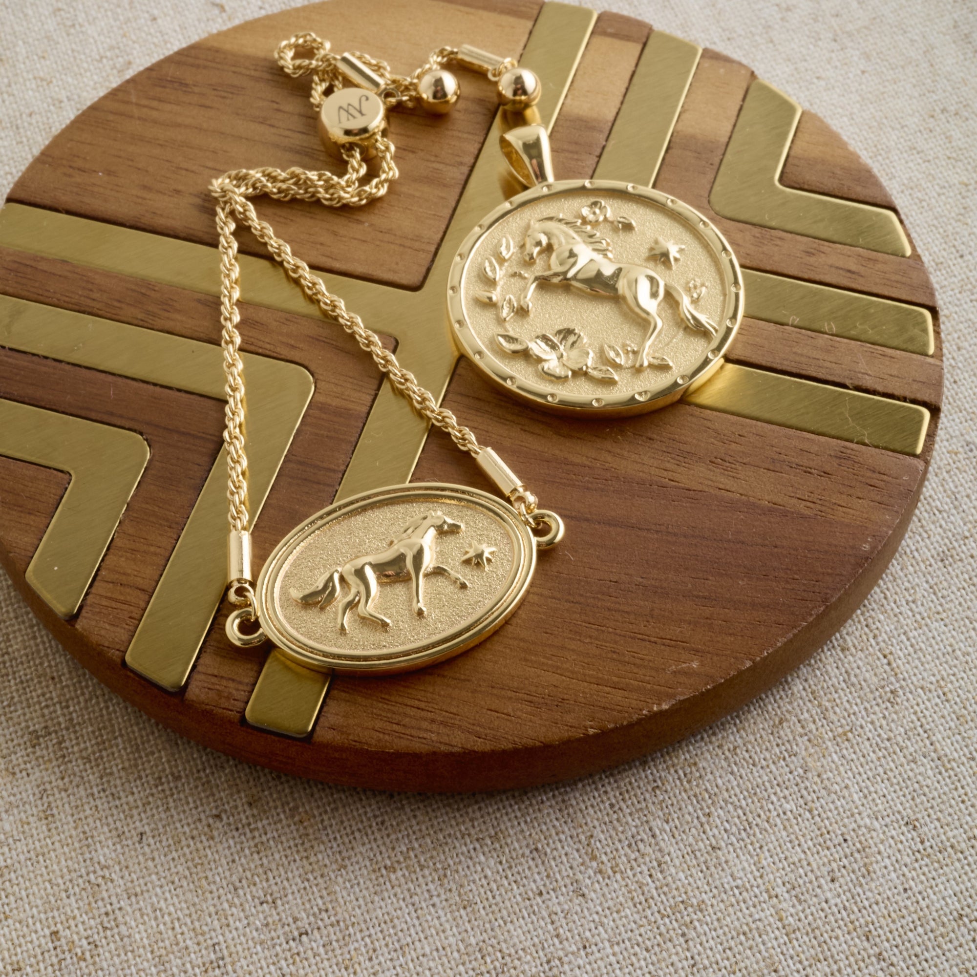 Stylized shot of the year of the horse pendant and bracelet