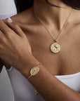 Model wearing the year of the horse coin pendant and bracelet