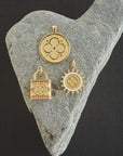 Stylized shot of love coin, love petite embellished coin, and locked up in love pendant