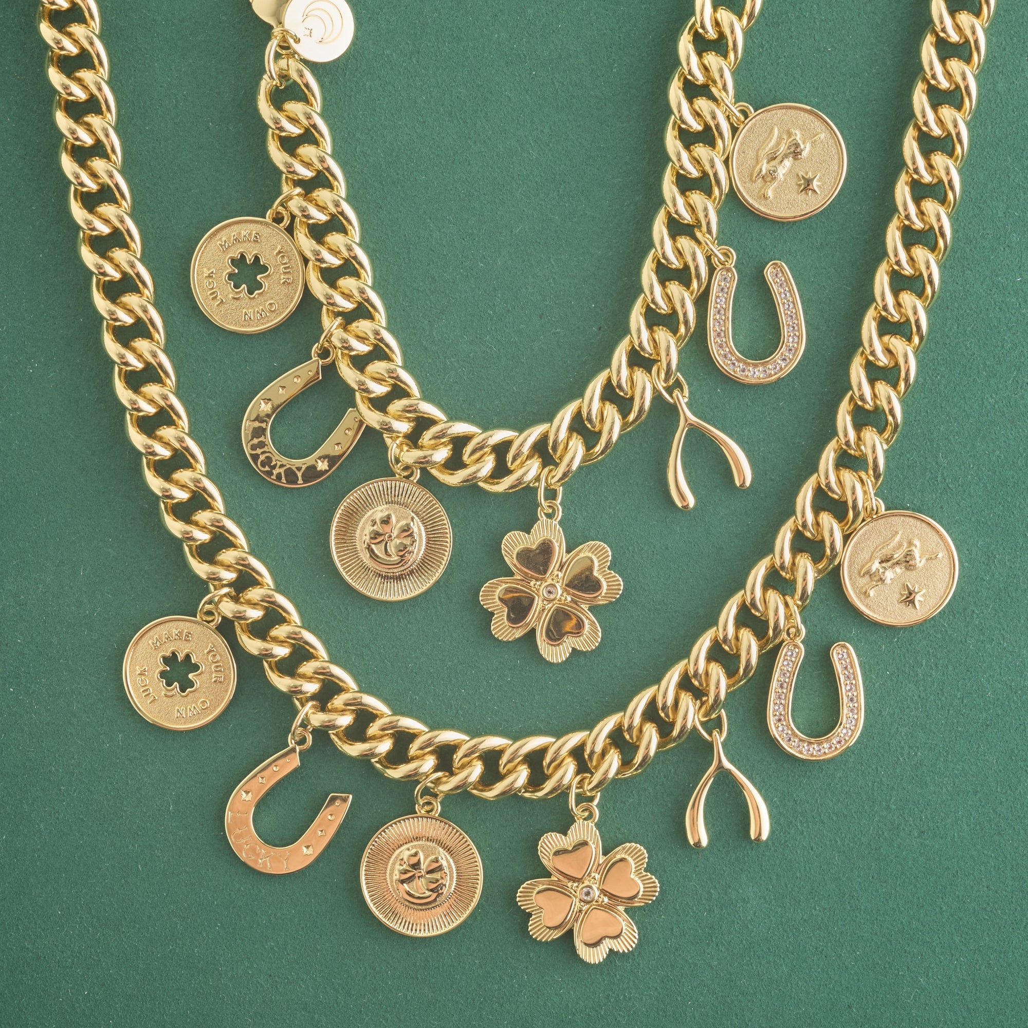 Stylized shot of lucky charm necklace and bracelet on green background