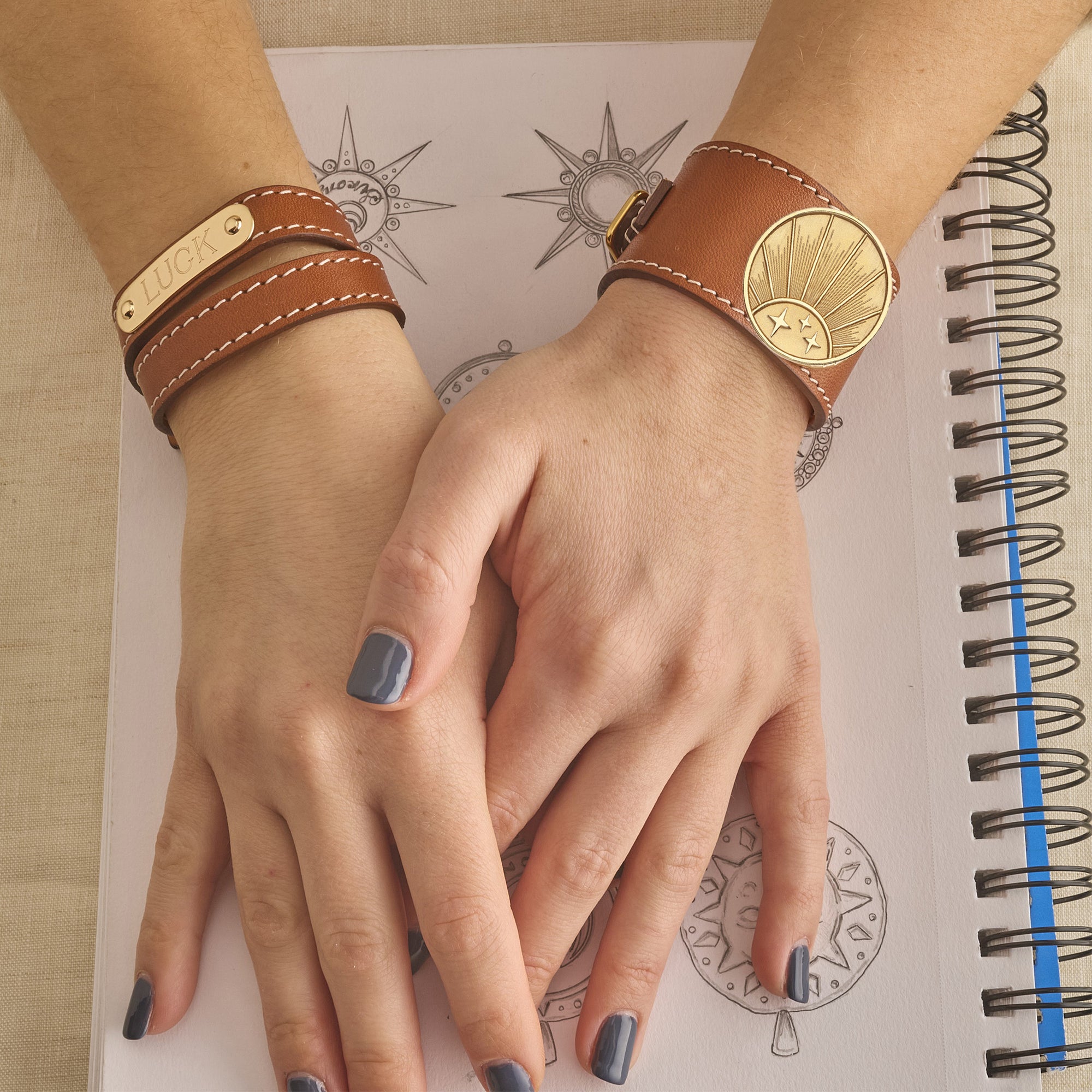 Model wearing leather rising sun cuff and leather engravable cuff