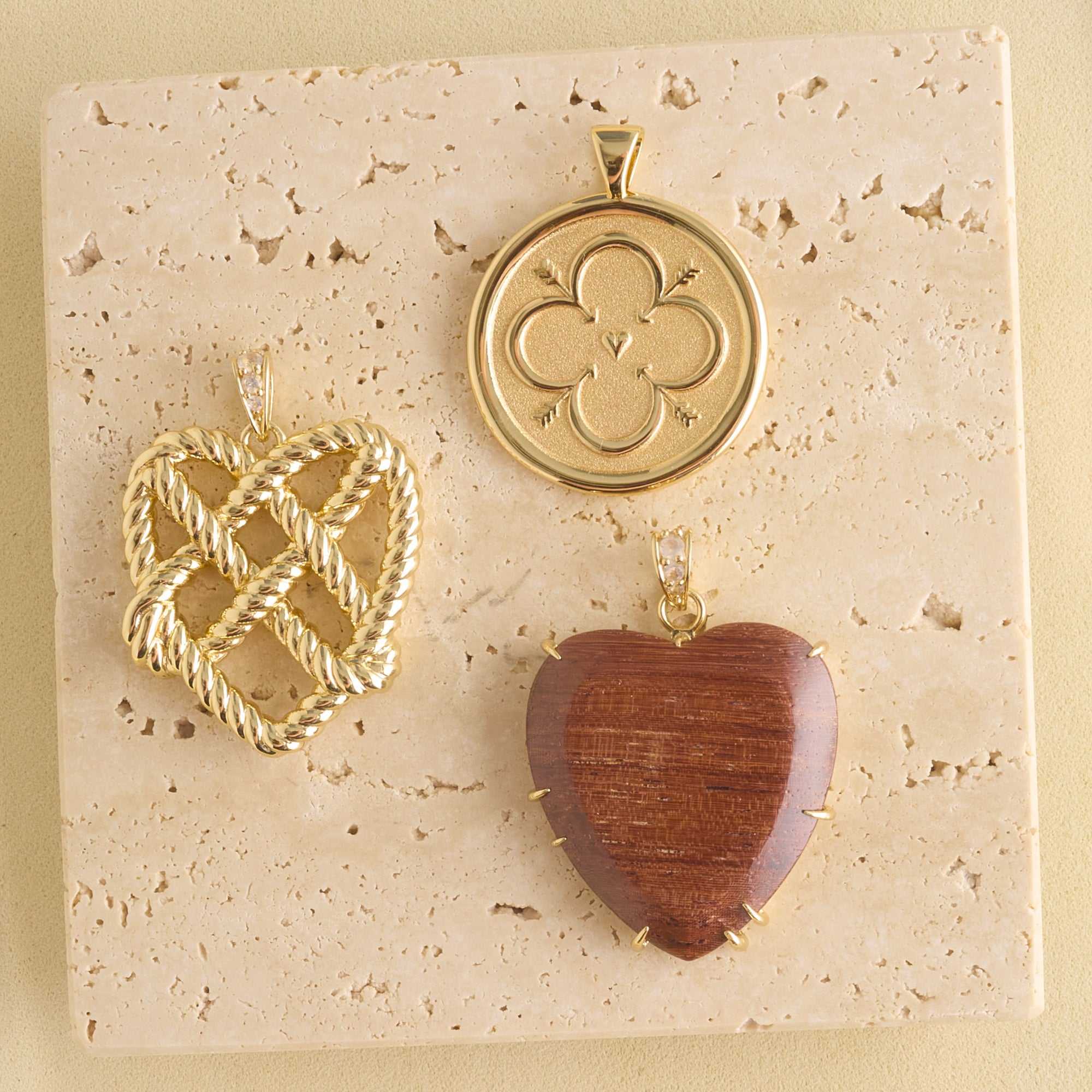 Stylized shot of love coin, love in a knot heart, and carved wood heart
