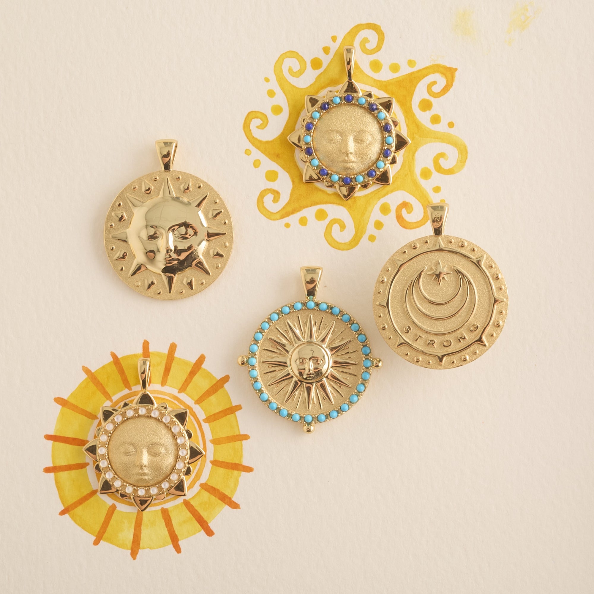 Stylized shot of assorted sun pendants with watercolor suns