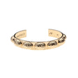Gold cuff bracelet with repeating 3D scarab motif